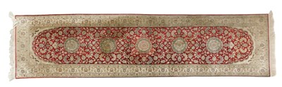 Lot 823 - A Persian red ground rug, with central lozenge...