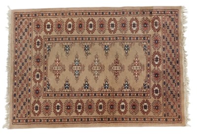 Lot 828 - A Persian Bokhara beige ground rug, decorated...