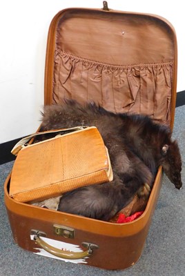 Lot 2270 - A vintage suitcase, containing fur items...