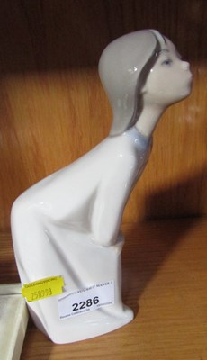 Lot 2286 - A Lladro figure of a young girl leaning with...