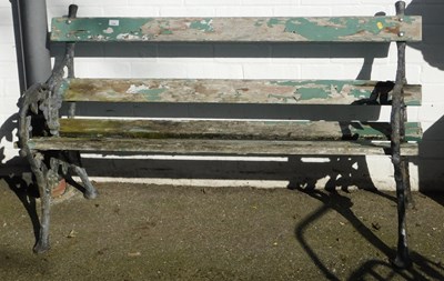 Lot 1142 - A wooden two seater garden bench, with cast...