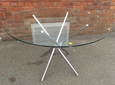 Lot 1010 - A glass circular topped dining table, on four...