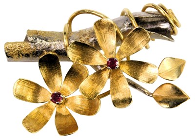 Lot 320 - An 18ct two colour gold and ruby set floral...