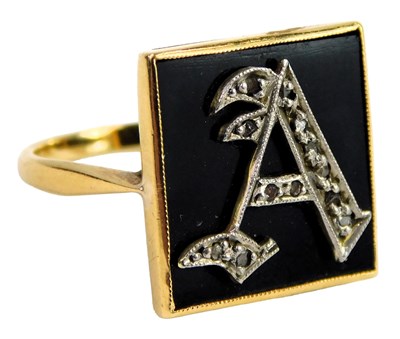 Lot 330 - A lady's black onyx and diamond initial ring,...