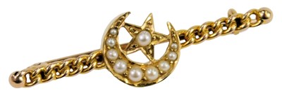 Lot 326 - A seed pearl set crescent moon and star bar...