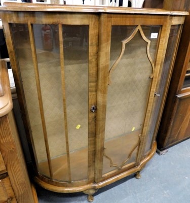 Lot 1524 - A walnut mid-century bow fronted two door...
