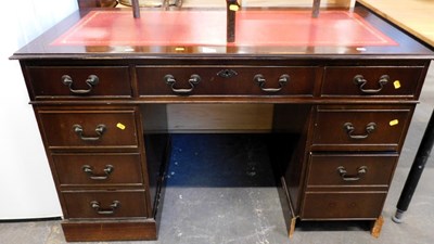 Lot 1550 - A mahogany kneehole desk, with nine drawers,...