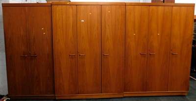 Lot 1604 - A late 20thC teak three door lockable wardrobe,...