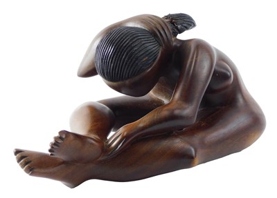 Lot 187 - An African carved hardwood figure of a female...