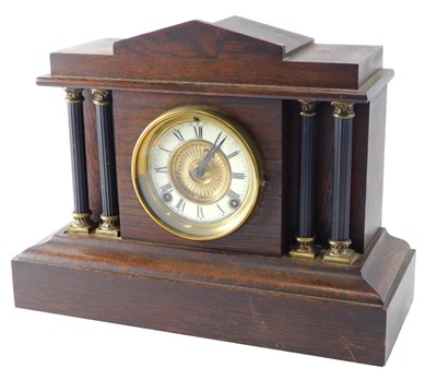 Lot 264 - An early 20thC oak cased mantel clock, the...