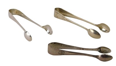 Lot 334 - Three pairs of silver sugar tongs, various...