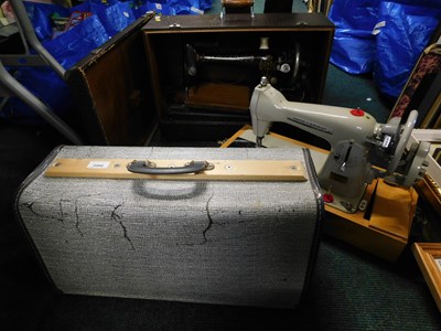 Lot 2080 - A cased Singer sewing machine, together with a...