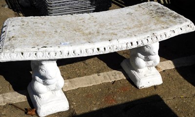 Lot 1669 - A painted composition stone garden bench, the...
