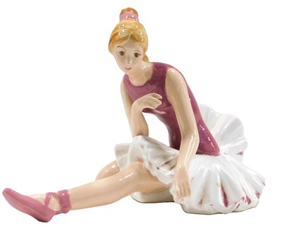 Lot 467 - A porcelain figure of a ballet dancer, in pink,...