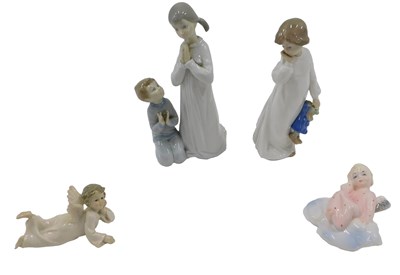 Lot 519 - A Nao porcelain figure of a girl with a doll,...