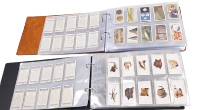 Lot 834 - Two albums of cigarette cards, to include...