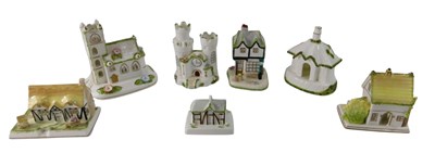 Lot 872 - A collection of seven Coalport cottages, to...
