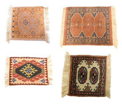Lot 970 - A small Afghan type rug, with medallions in a...