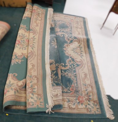 Lot 1676 - A large late 20thC wool blend rug, with floral...