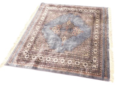 Lot 1033 - An Afghan style carpet, with a central lozenge...