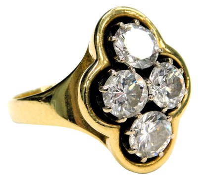 Lot 92 - An 18ct gold and diamond four stone ring, in a...