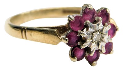 Lot 521 - A 9ct gold ruby and diamond flower head ring,...