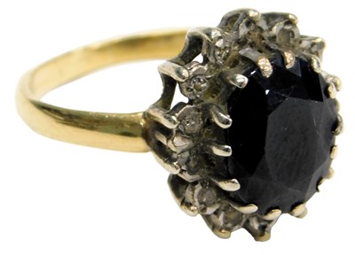 Lot 523 - A sapphire and diamond ring, the oval cut...