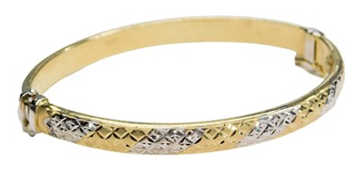Lot 577 - A two colour bangle, in a lattice design, on a...