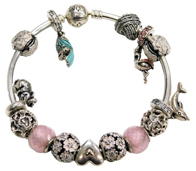 Lot 583 - A Pandora bangle, set with fourteen charms, on...
