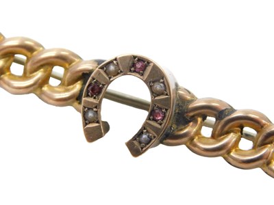 Lot 546 - A Victorian horseshoe brooch, set with rubies...
