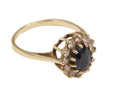 Lot 587 - A 9ct gold sapphire and CZ ring, in an oval...