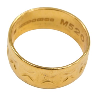 Lot 561 - A 22ct gold wedding band, with engraved...