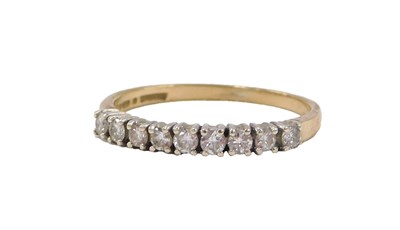 Lot 558 - A 9ct gold and diamond nine stone ring, in a...