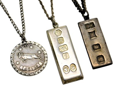 Lot 600 - Two silver ingot pendants, and an Aries...