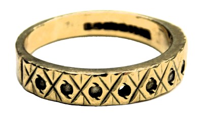 Lot 606 - A 9ct gold and CZ ring, in a rub over setting,...