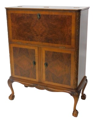 Lot 1018 - A mid 20thC walnut and figured walnut cocktail...