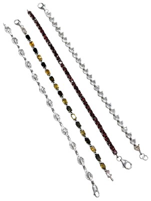 Lot 639 - Four silver and paste set bracelets, of...