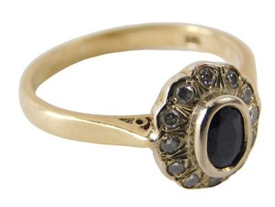 Lot 717 - A 9ct gold sapphire and diamond ring, the oval...