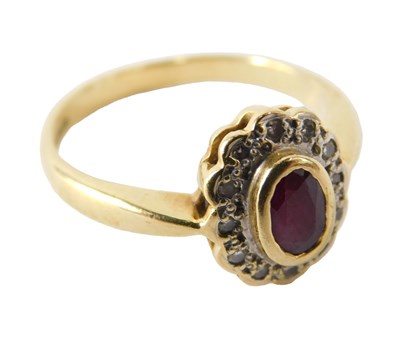 Lot 716 - An 18ct gold ruby and diamond ring, the oval...