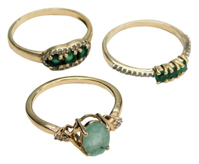 Lot 770 - A 9ct gold and emerald three stone ring, with...
