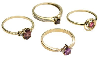 Lot 764 - Four 9ct gold and gem set rings, variously...