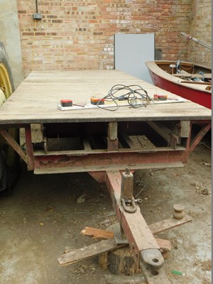 Lot 15 - A red single-axle farm trailer, with a wooden...