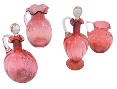 Lot 920 - A cranberry tinted claret jug, with raised...