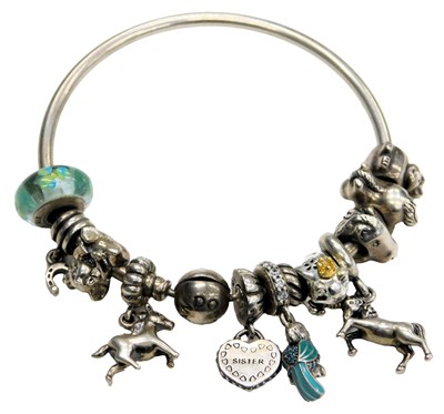 Lot 580 - A Pandora bracelet, with various charms to...