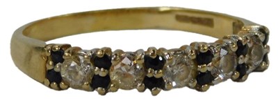 Lot 30 - A CZ and sapphire dress ring, the five round...