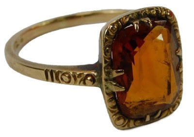 Lot 57 - A citrine dress ring, claw set in a scrolling...