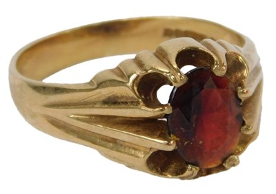 Lot 59 - A 9ct gold and garnet ring, the oval central...