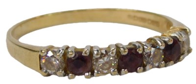 Lot 62 - A 9ct gold seven stone ring, set with white...