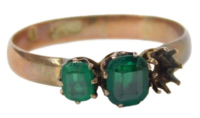 Lot 64 - An emerald paste three stone ring, claw set,...