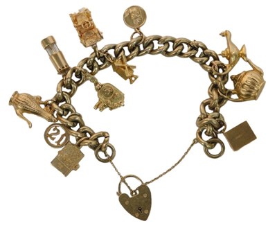 Lot 98 - A gold plated curb link charm bracelet, with a...